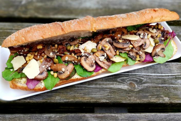 Mushroom sandwich with pine nuts, raisins, artichokes and capers
