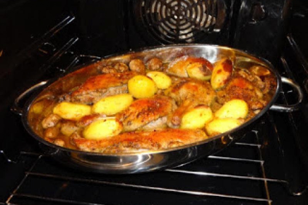 Pieczona kaczka z ziemniakami i pieczarkami.